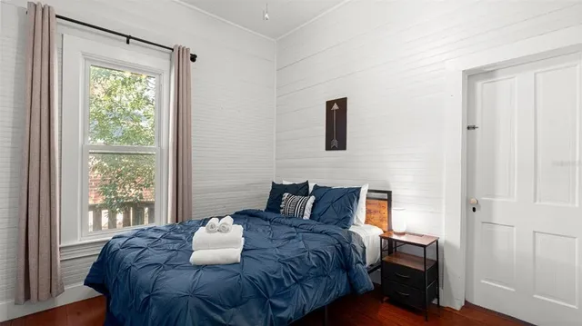 a bedroom with a bed and a window