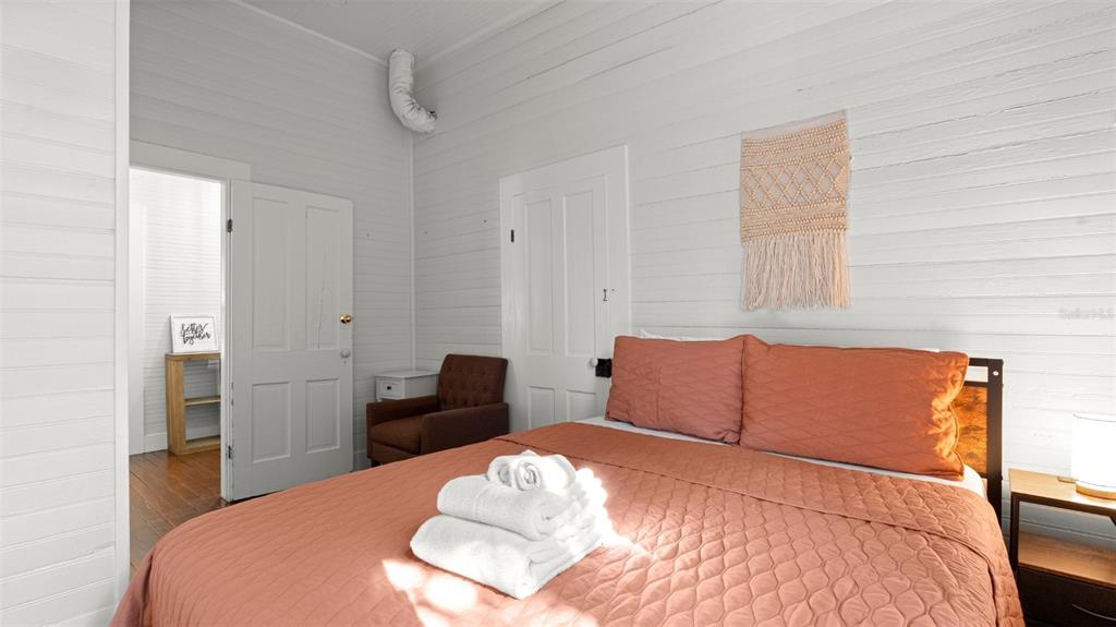 101 Northeast 9th Street Gainesville, FL 32601 - Photo 16 of 35 a bedroom with a bed and a chair