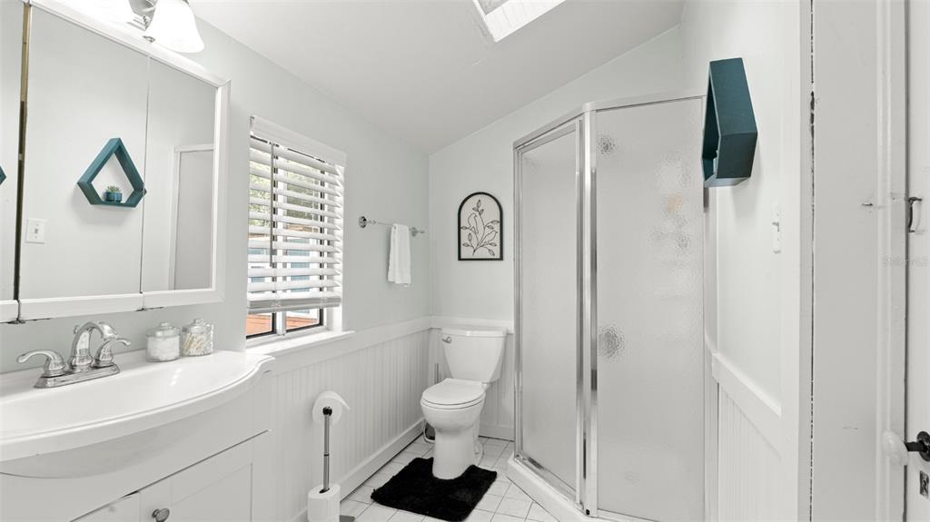 101 Northeast 9th Street Gainesville, FL 32601 - Photo 18 of 35 a bathroom with a sink a toilet and a mirror