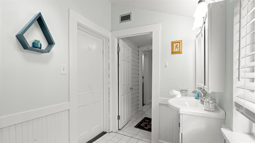 101 Northeast 9th Street Gainesville, FL 32601 - Photo 19 of 35 a bathroom with a sink and a mirror