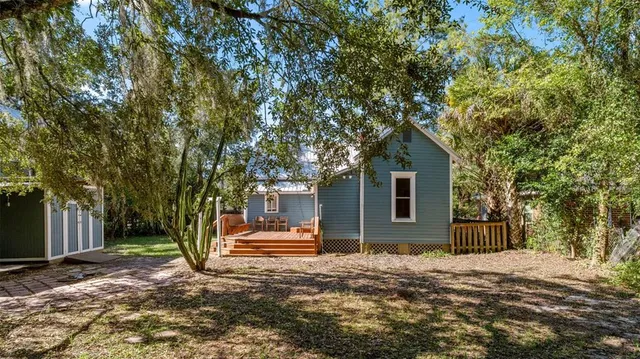 a view of a house with a tree in front of it