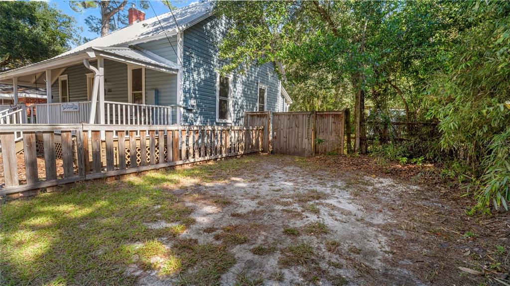 101 Northeast 9th Street Gainesville, FL 32601 - Photo 34 of 35 a view of a house with a small yard and wooden fence