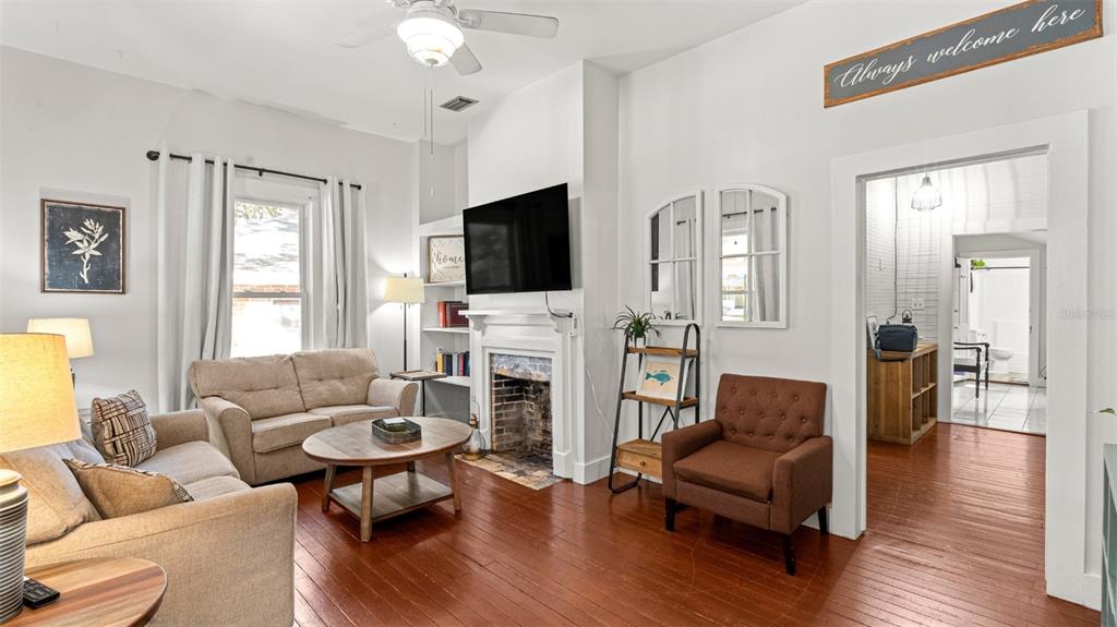 101 Northeast 9th Street Gainesville, FL 32601 - Photo 6 of 35 a living room with furniture a fireplace and a flat screen tv