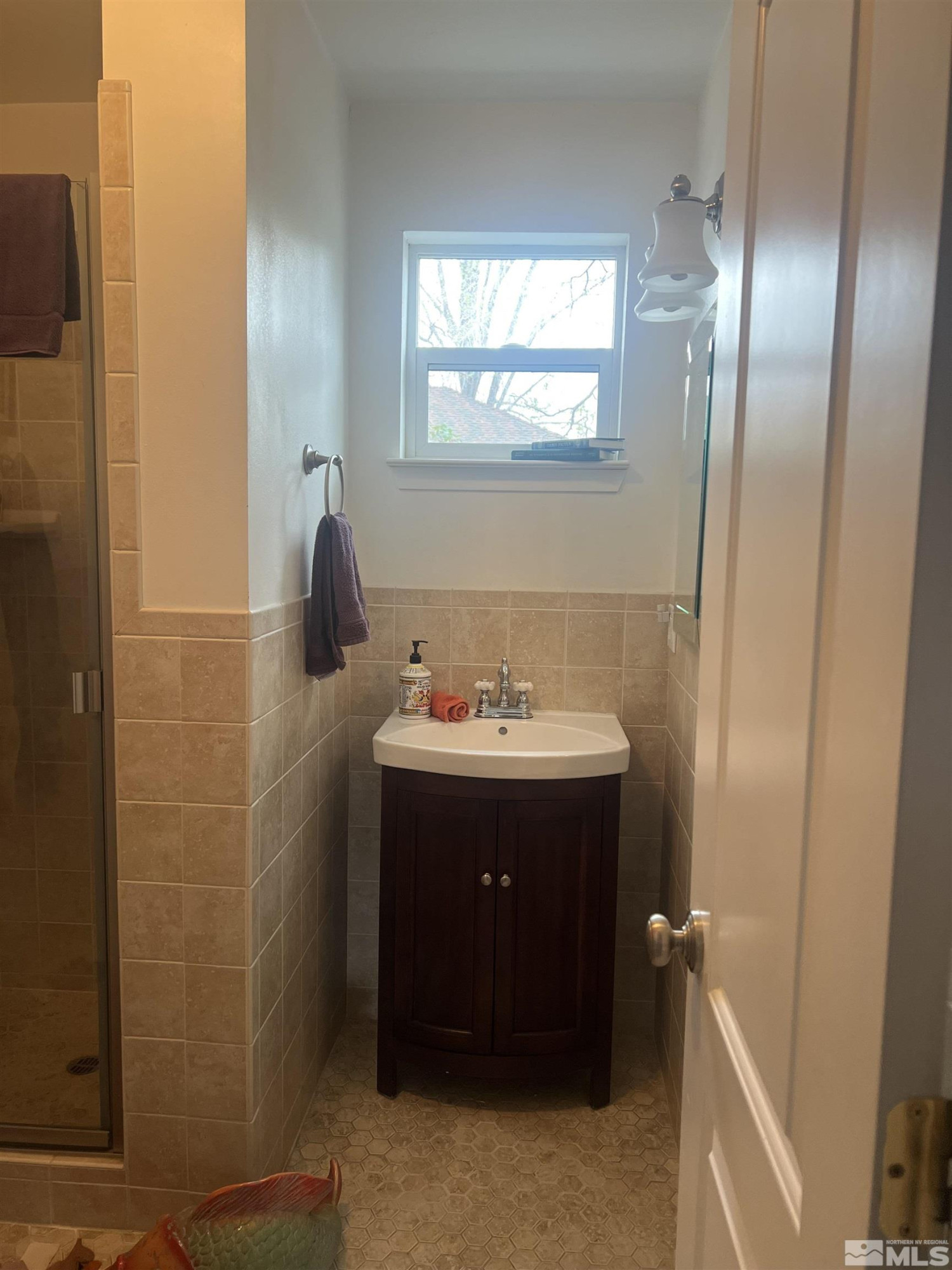104 Virginia Street Yerington, NV 89447 - Photo 14 of 15 a bathroom with a sink and mirror with shower