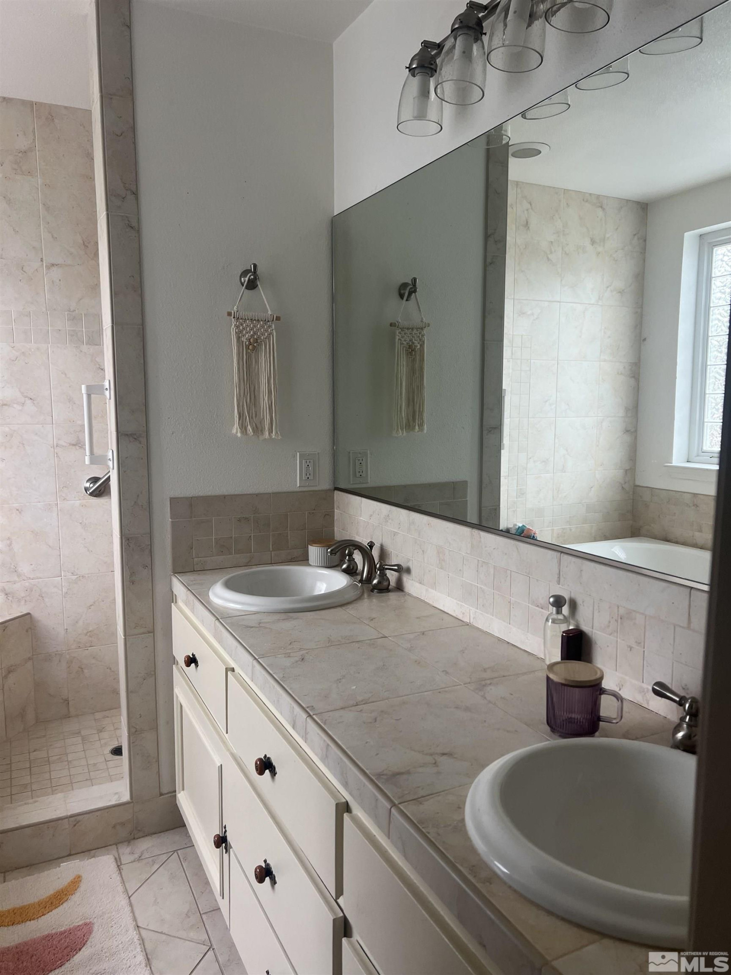 104 Virginia Street Yerington, NV 89447 - Photo 7 of 15 a bathroom with double sink and a mirror