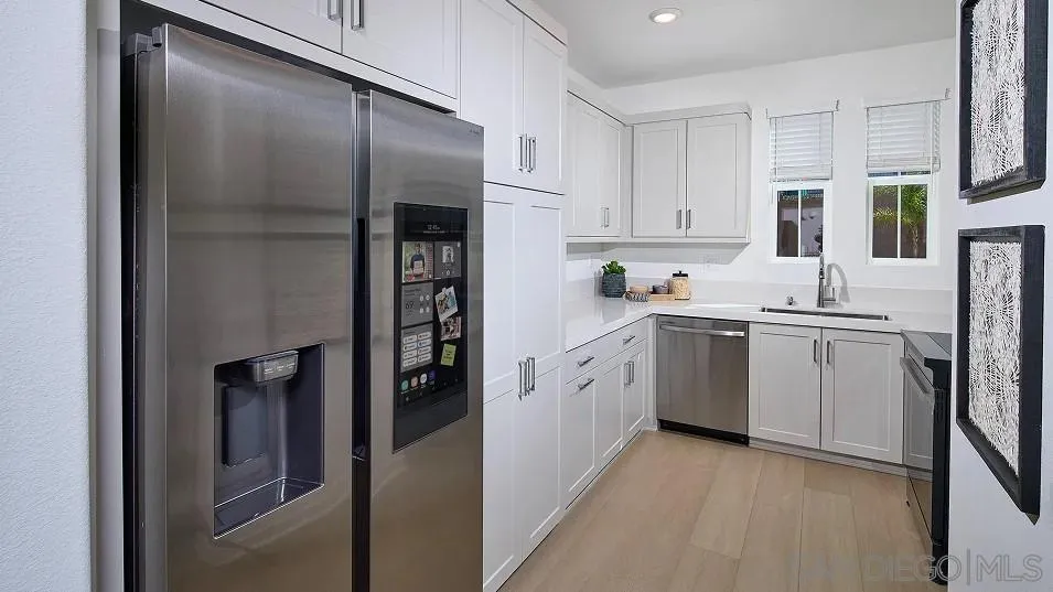 1212 Mountain Laurel Road San Marcos, CA 92078 - Photo 3 of 18 a kitchen with a refrigerator sink and cabinets