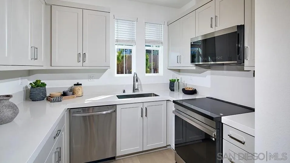 1212 Mountain Laurel Road San Marcos, CA 92078 - Photo 4 of 18 a kitchen with a sink stove and microwave
