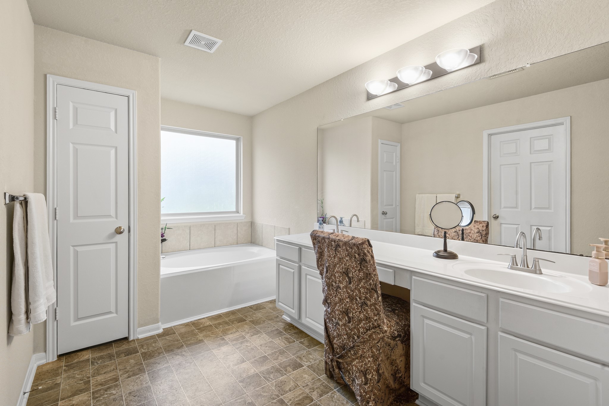 5211 Cayenne Lane Baytown, TX 77521 - Photo 11 of 19 The en suite bathroom has dual vanities, a soaking tub, and large walk in closet.