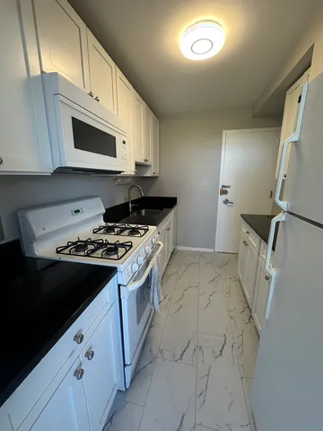 a kitchen with a stove and a microwave