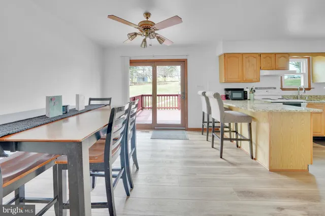 a view of a a dining room with furniture window and wooden floor
