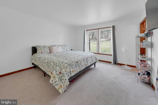 a bed sitting in a room next to a window