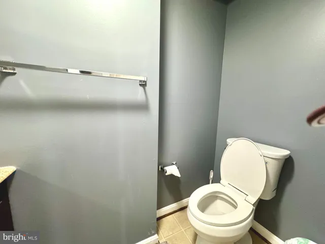 a view of garden with plants and wooden fence