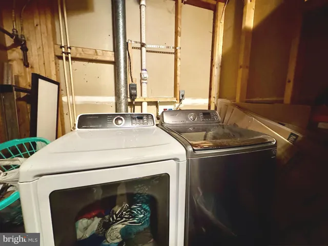 a view of a backyard with table and chairs potted plants with wooden fence