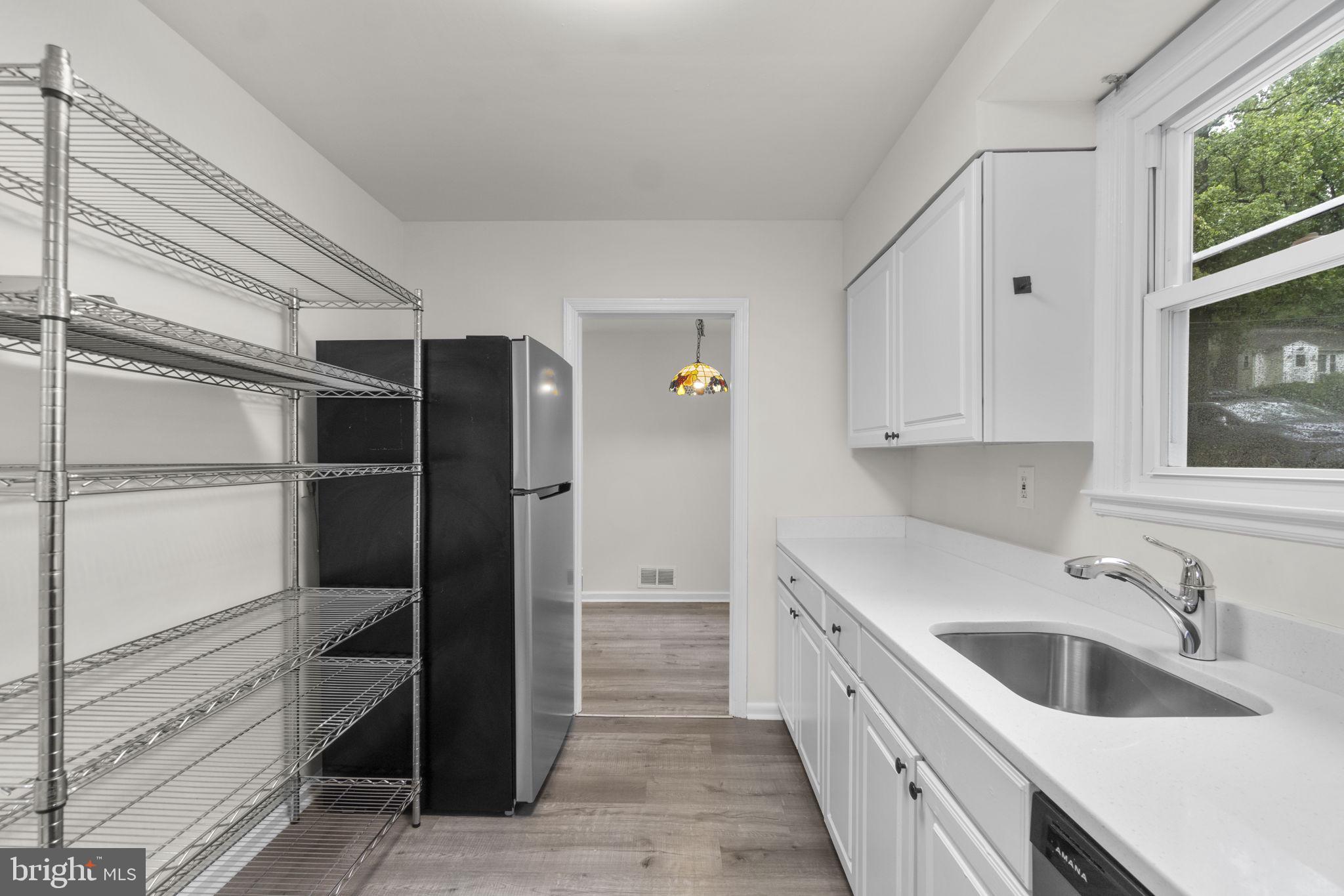 3658 Clifmar Road Baltimore, MD 21244 - Photo 20 of 43 a kitchen with a sink and a refrigerator