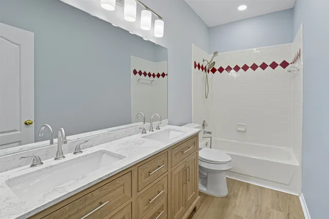 a bathroom with a sink vanity mirror and toilet