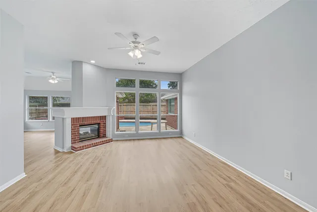 wooden floor in an empty room with a fireplace