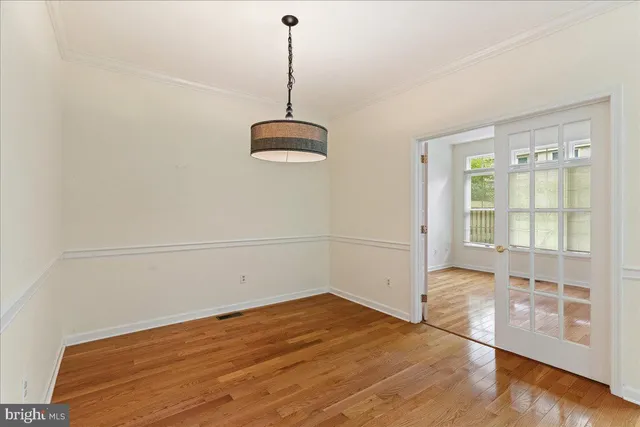 a view of a room with wooden floor and white walls