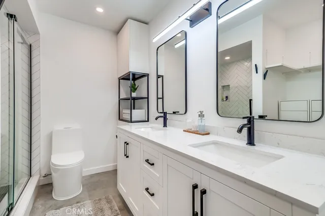 a bathroom with a shower a toilet and sink