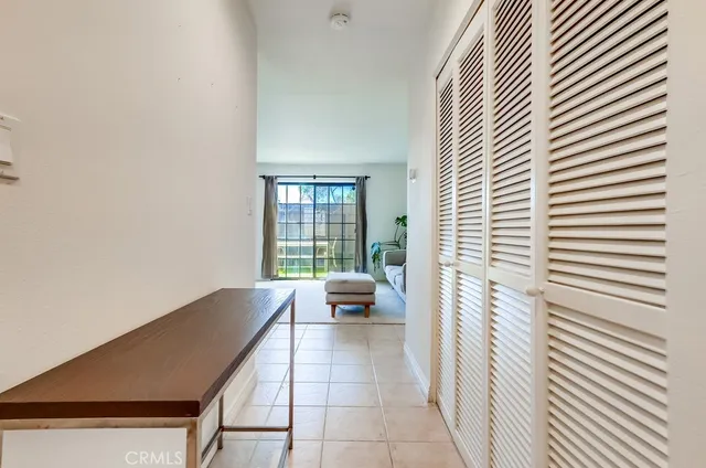 a hallway with a white walls and a large window