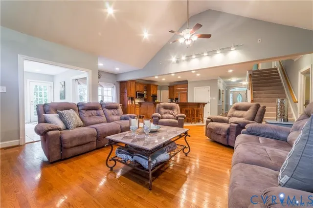 a living room with furniture and large windows