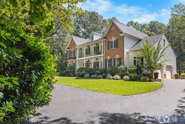a front view of a house with a garden and deck