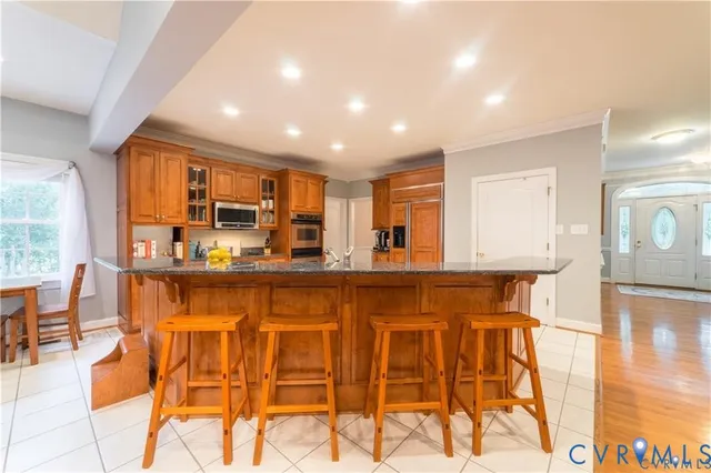 a kitchen with stainless steel appliances granite countertop a sink and cabinets