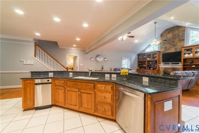 a living room with furniture a rug and a bookshelf