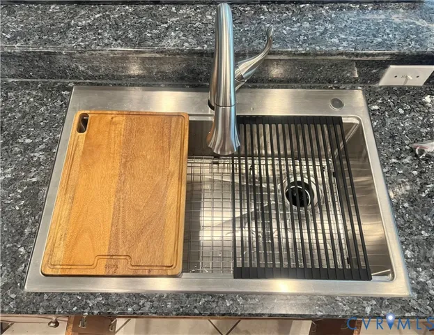 a living room with furniture a chandelier and a wooden floor