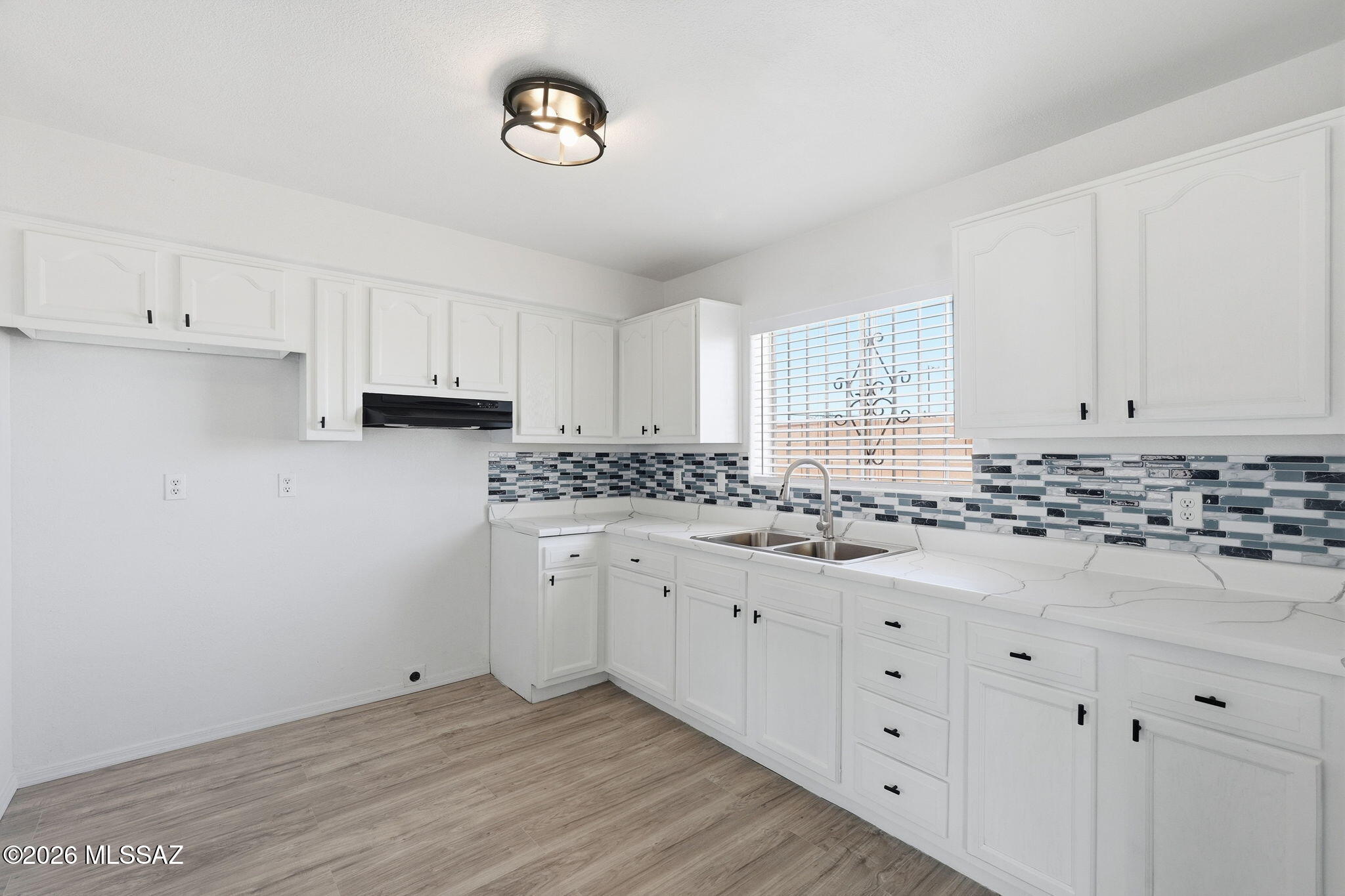 136 West Elvira Road Tucson, AZ 85756 - Photo 14 of 27 a kitchen with granite countertop white cabinets and white appliances