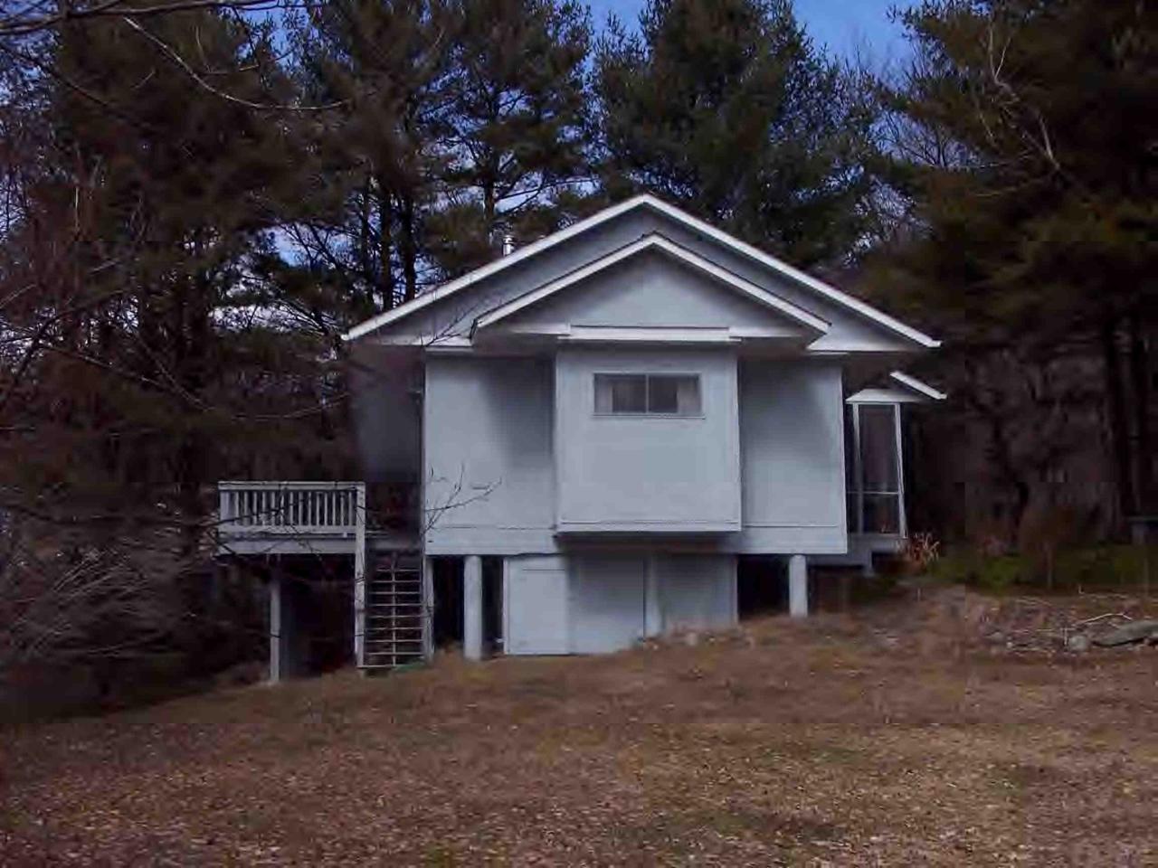 97 Werden Road Otis, MA 01253 - Photo 3 of 5 a front view of a house with yard and trees