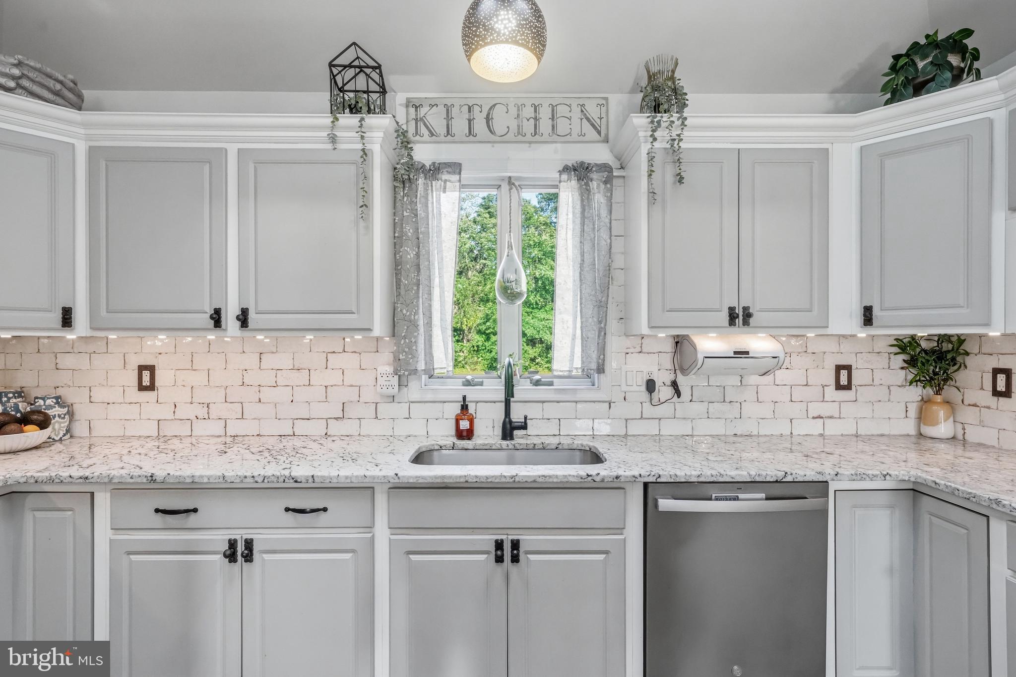 705 Garden Road Pittsgrove, NJ 08318 - Photo 27 of 72 a kitchen with stainless steel appliances granite countertop a sink a window and cabinets