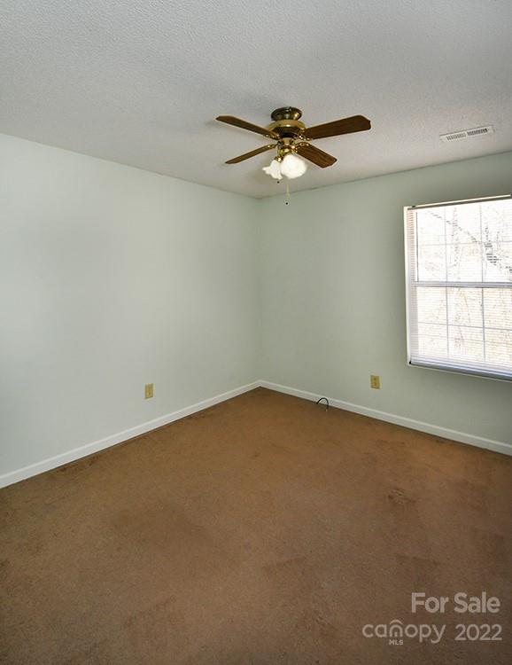 104 Queensbury Road Troutman, NC 28166 - Photo 13 of 24 an empty room with a window and a fan