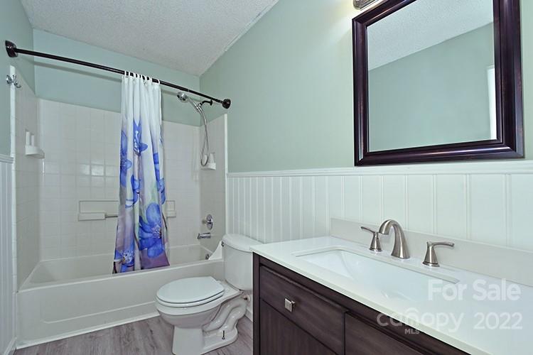 104 Queensbury Road Troutman, NC 28166 - Photo 16 of 24 a bathroom with a granite countertop sink toilet and shower