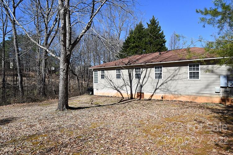 104 Queensbury Road Troutman, NC 28166 - Photo 20 of 24 a view of a backyard with a bench