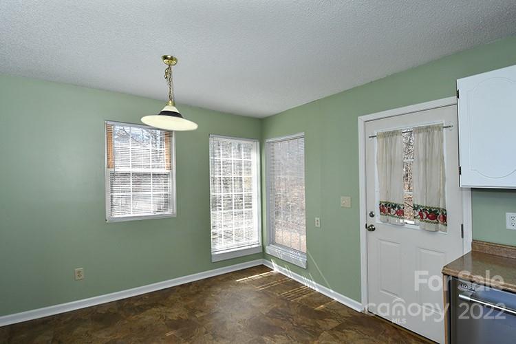 104 Queensbury Road Troutman, NC 28166 - Photo 6 of 24 a view of an empty room with window and cabinet