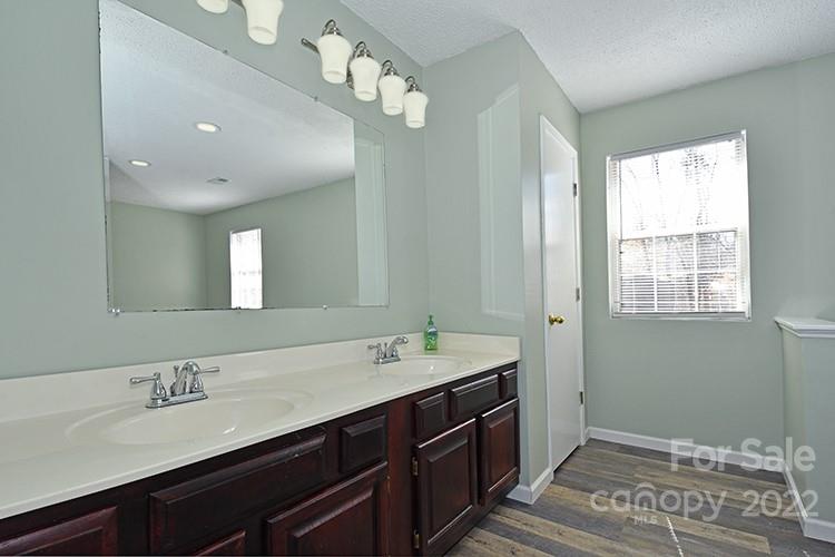 104 Queensbury Road Troutman, NC 28166 - Photo 8 of 24 a spacious bathroom with a double vanity sink and a mirror