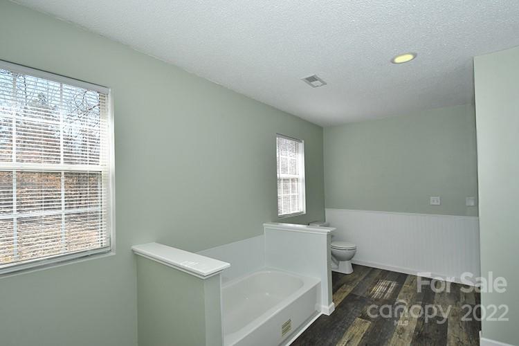 104 Queensbury Road Troutman, NC 28166 - Photo 9 of 24 a bathroom with a bathtub and window