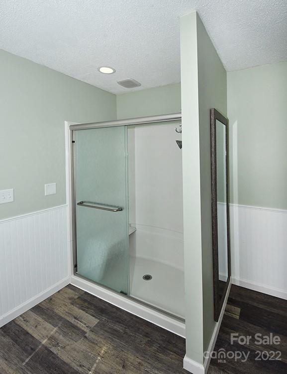 104 Queensbury Road Troutman, NC 28166 - Photo 10 of 24 a bathroom with a glass shower door