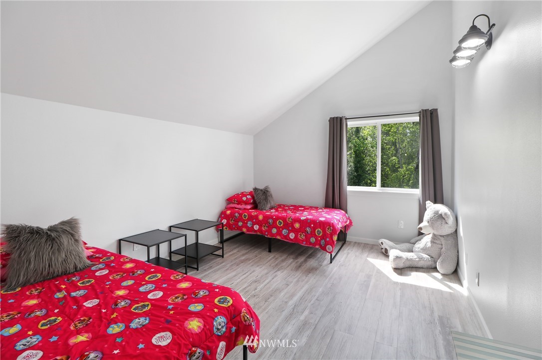 706 2nd Street Steilacoom, WA 98388 - Photo 17 of 35 a bedroom with a bed purple white bedspread and pillows