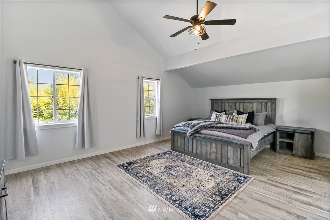 706 2nd Street Steilacoom, WA 98388 - Photo 24 of 35 a bedroom with a bed and wooden floor