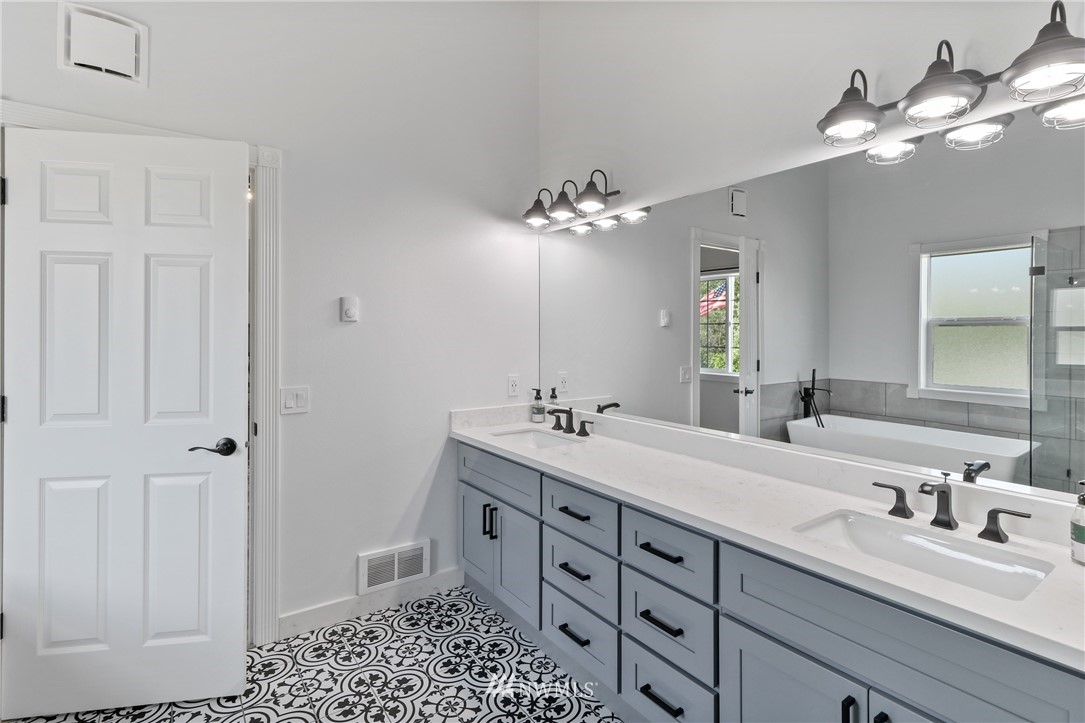 706 2nd Street Steilacoom, WA 98388 - Photo 29 of 35 a bathroom with a double vanity sink and a mirror