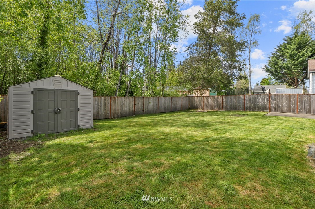 706 2nd Street Steilacoom, WA 98388 - Photo 33 of 35 a view of a backyard with a small cabin and a chair