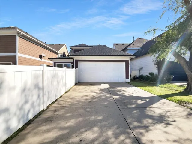 a view of a white house with a yard