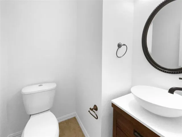 a white toilet sitting next to a bathroom sink