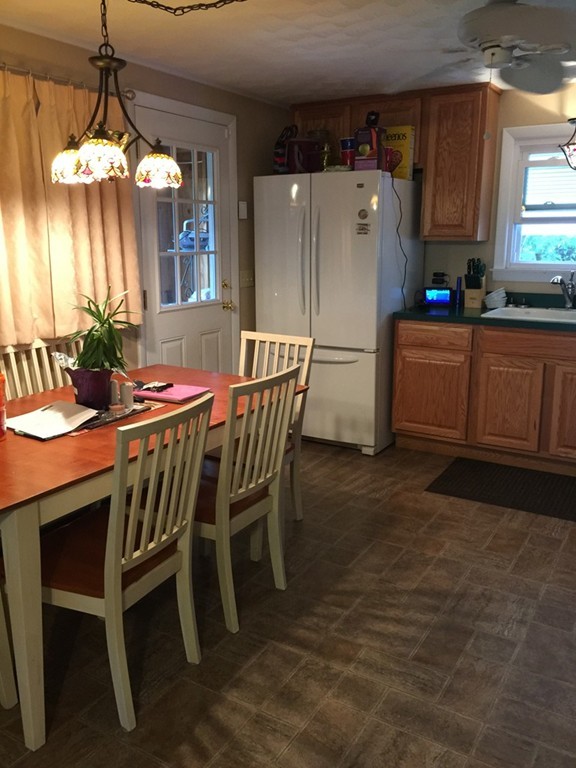 80 Temby Street Springfield, MA 01119 - Photo 12 of 30 a kitchen with a dining table chairs and refrigerator