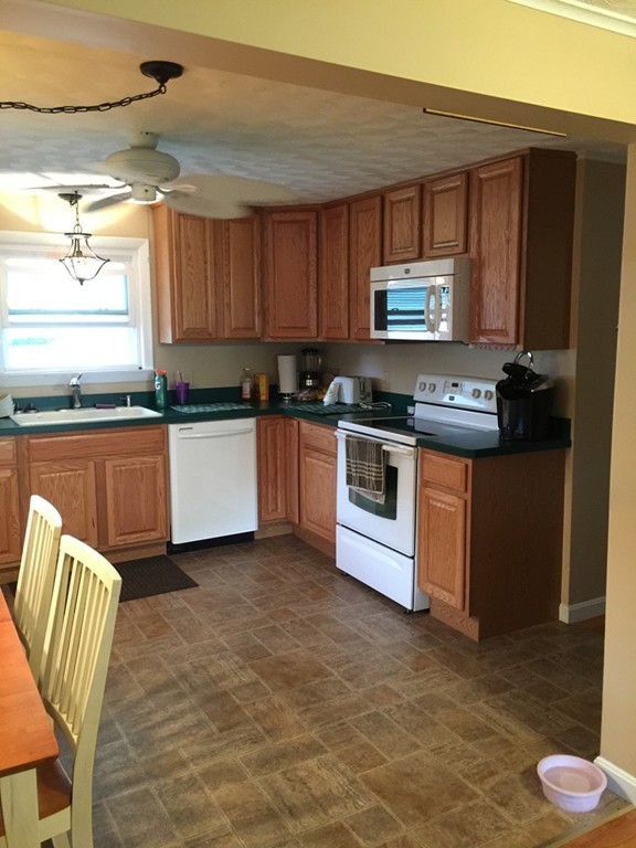 80 Temby Street Springfield, MA 01119 - Photo 9 of 30 a kitchen with stainless steel appliances granite countertop a stove top oven a sink and a microwave