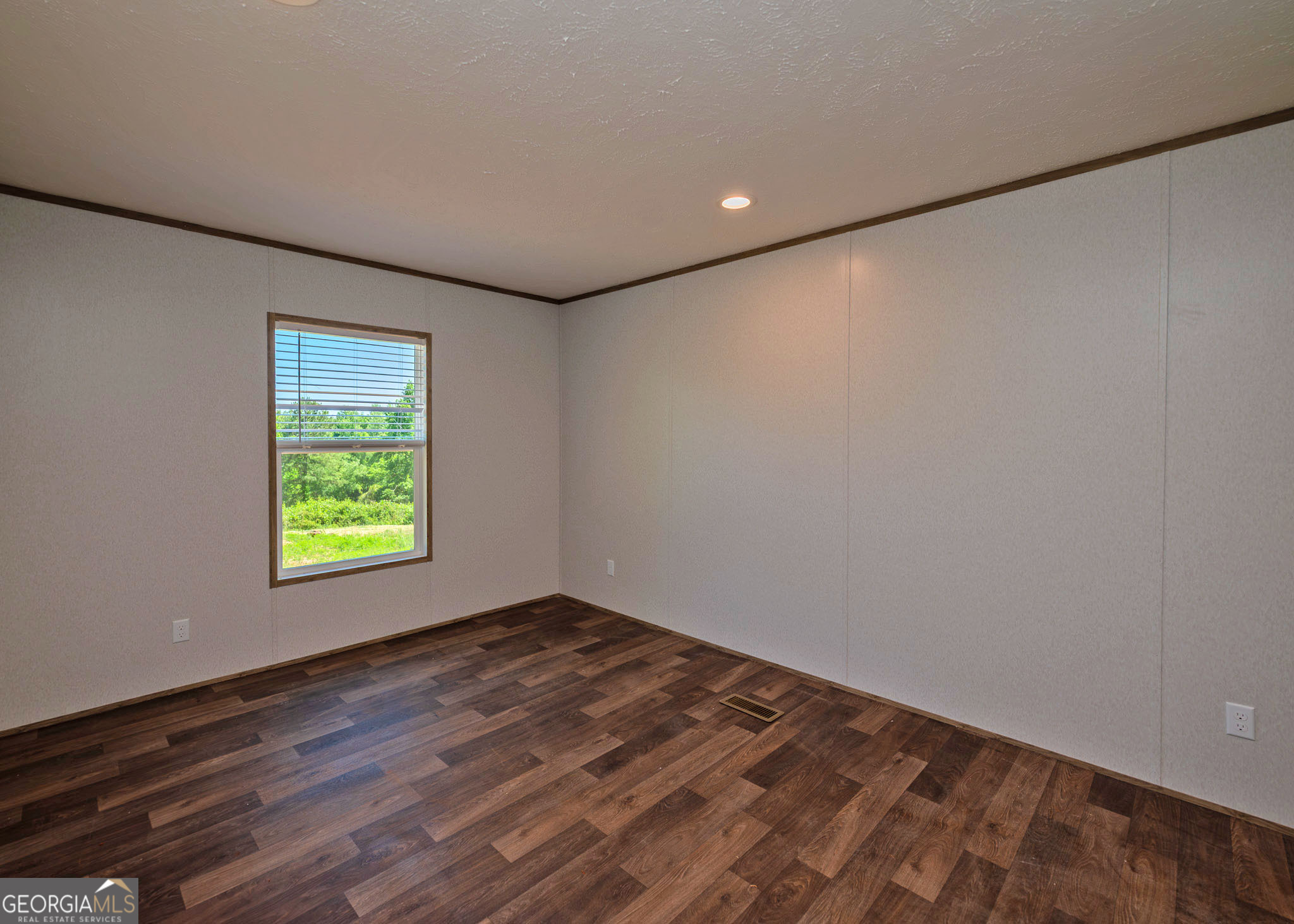 413 Griffin Road Martin, GA 30557 - Photo 23 of 31 a view of an empty room with wooden floor and a window