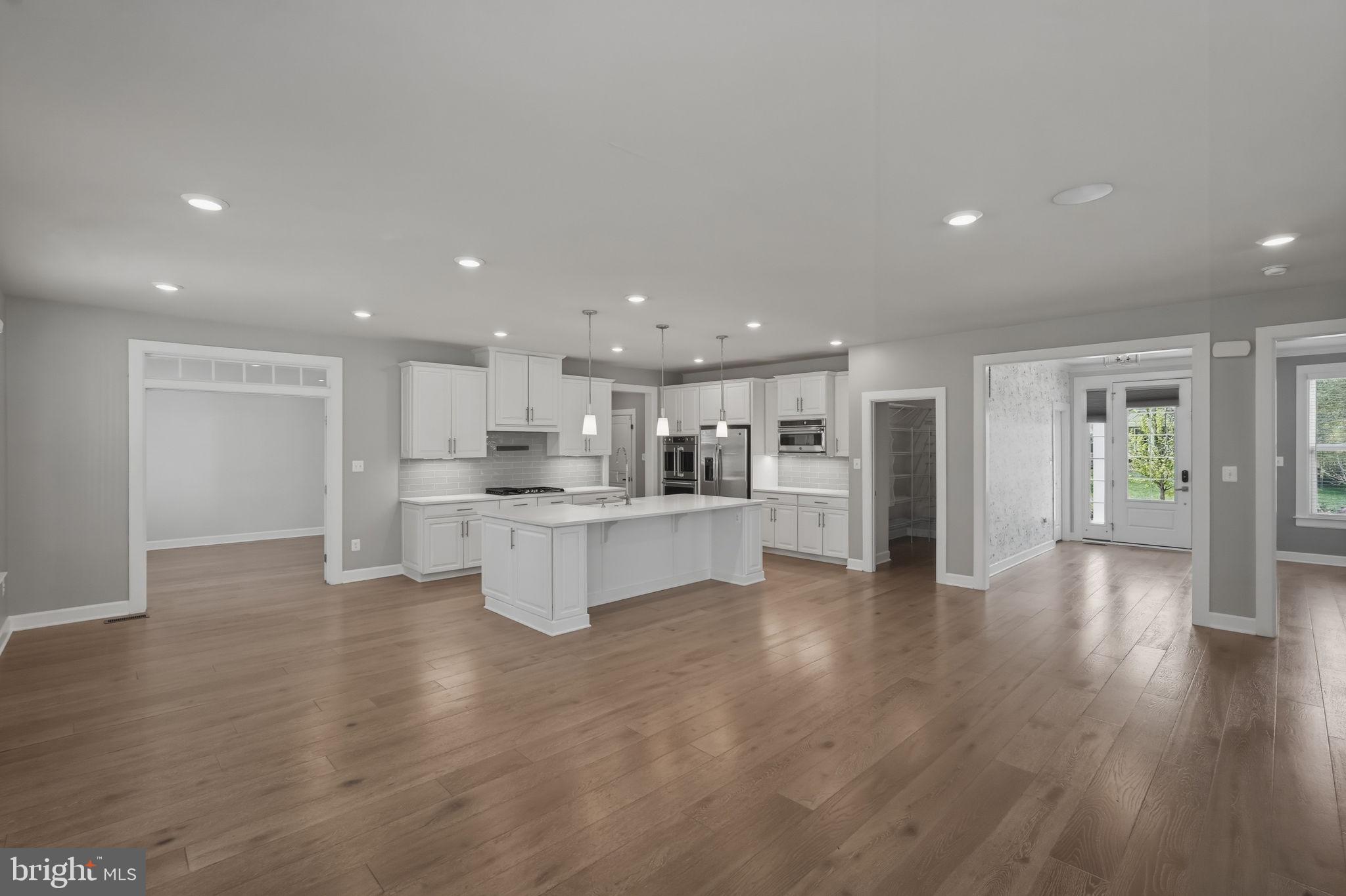 23648 Amesfield Place Aldie, VA 20105 - Photo 11 of 41 a large kitchen with white cabinets and wooden floor