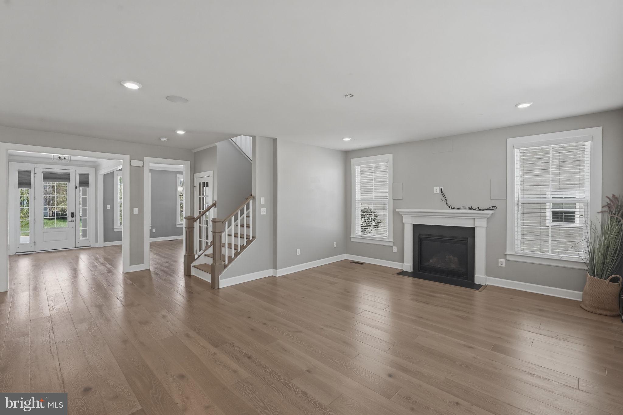 23648 Amesfield Place Aldie, VA 20105 - Photo 13 of 41 a view of a livingroom with wooden floor and a fireplace