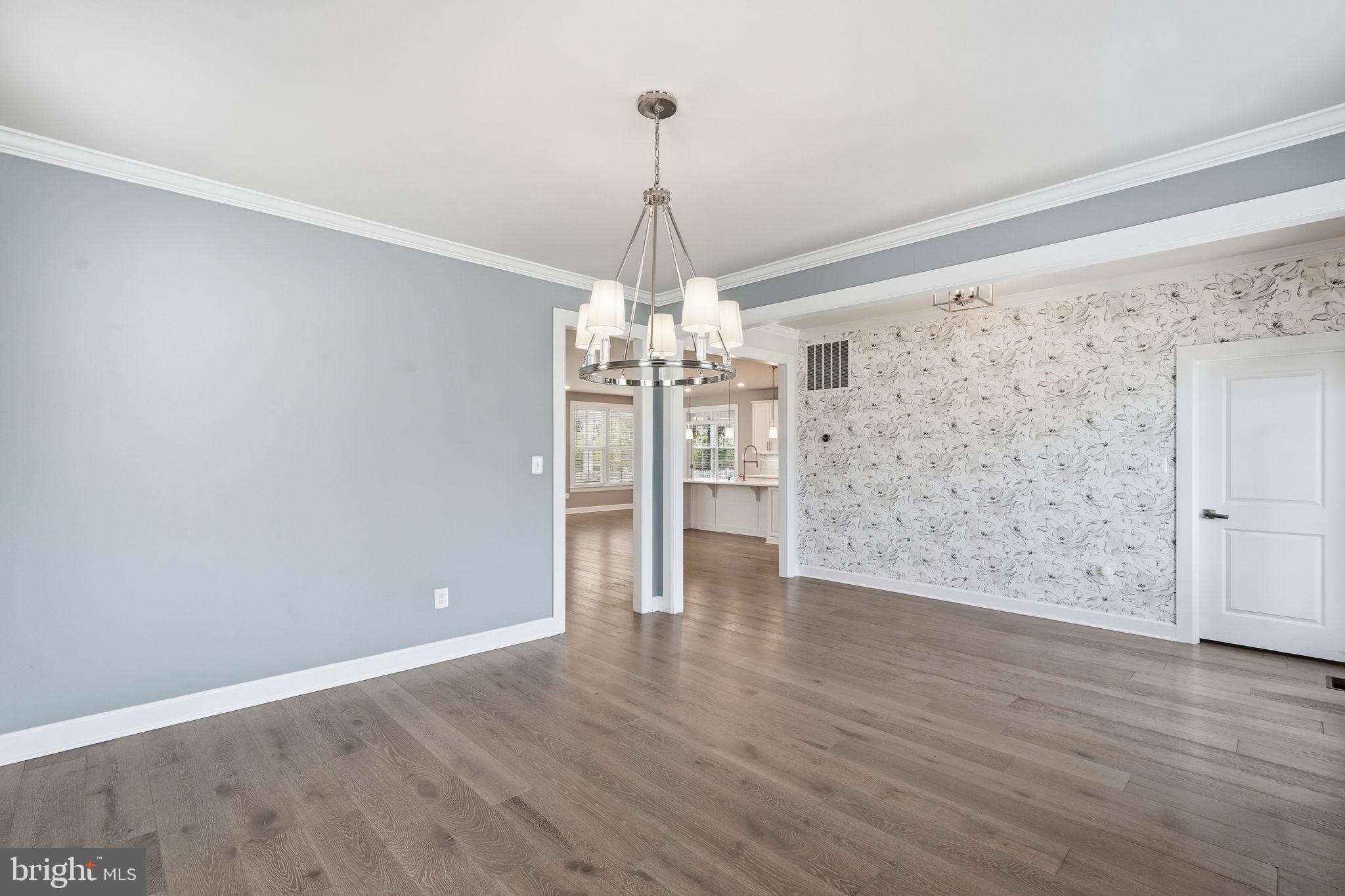 23648 Amesfield Place Aldie, VA 20105 - Photo 16 of 41 a view of a livingroom with wooden floor a chandelier and entryway